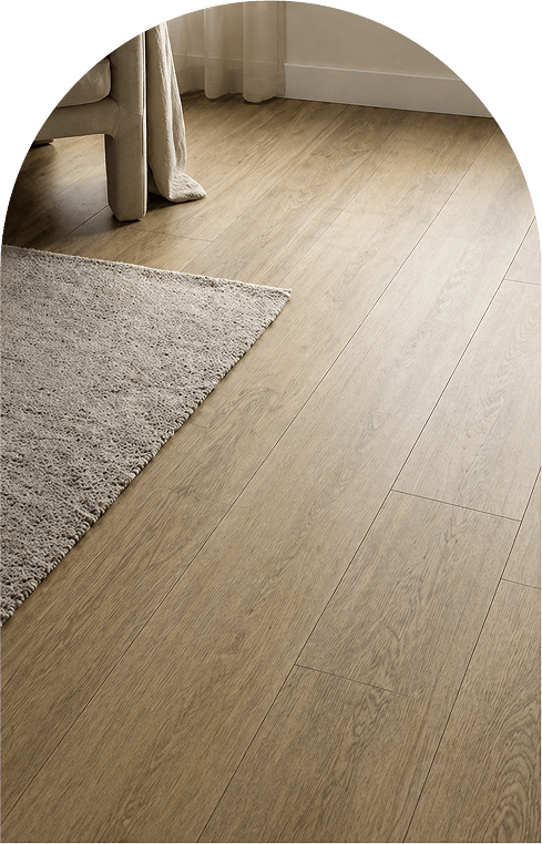 A cozy room featuring a wooden floor and a comfortable couch, creating a warm and inviting atmosphere.
